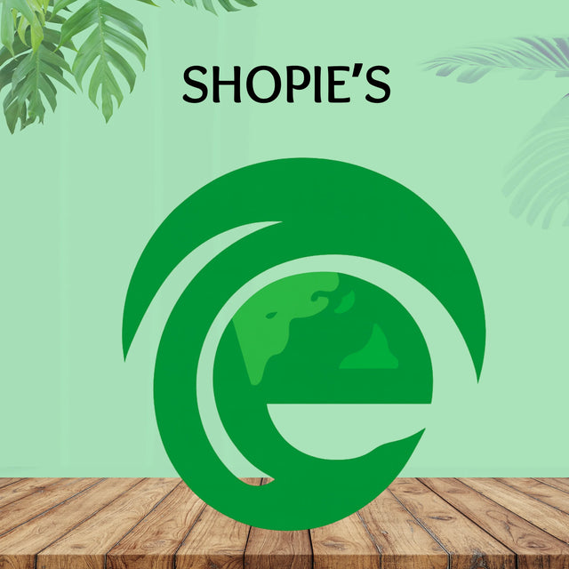 Shoppiearth UK green eco logo on wood table with tropical leaves, lifestyle and wellness theme