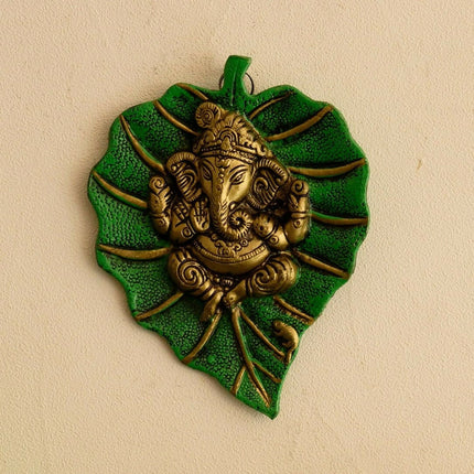 eCraftIndia Metal Golden Lord Ganesha On Green Leaf Wall Hanging Sculpture